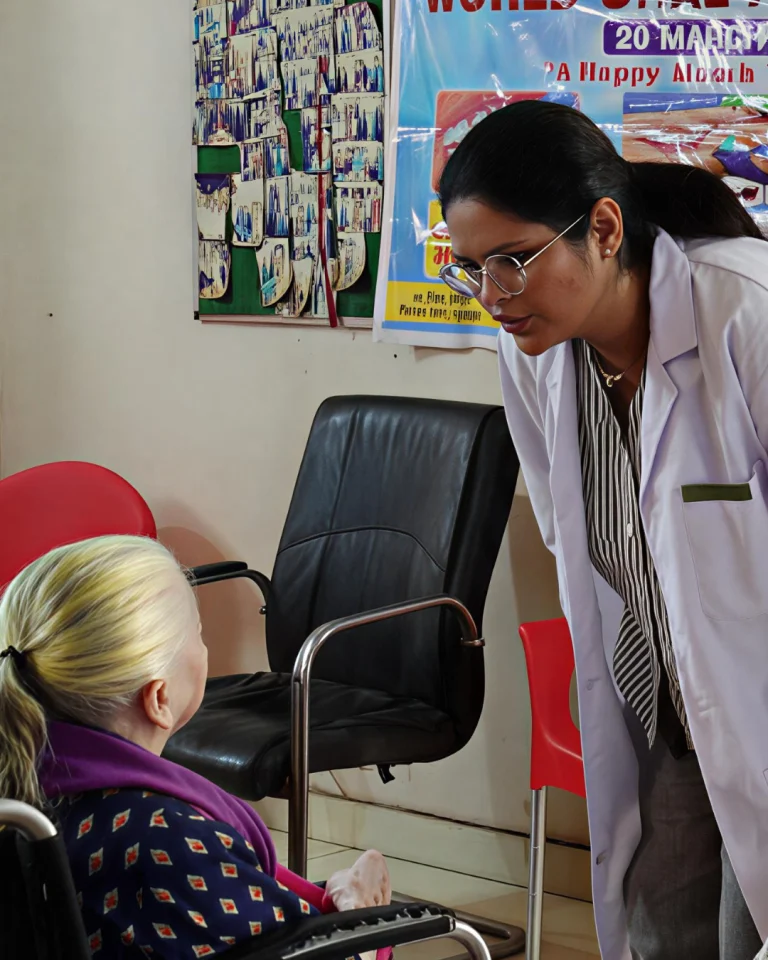 Healthcare professional interacting with a resident at Saksham by Kriti