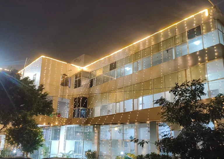 Saksham by Kriti building illuminated at night in Gurgaon