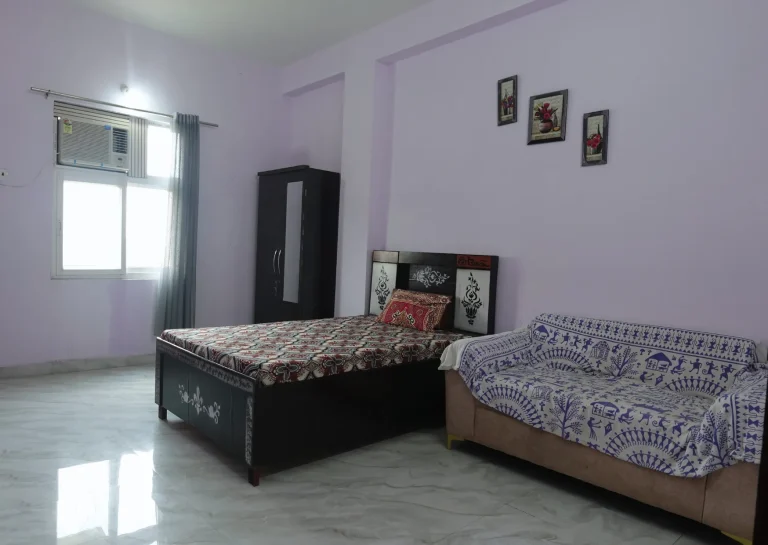Residential room with bed, sofa and wardrobe at Saksham by Kriti in Gurgaon