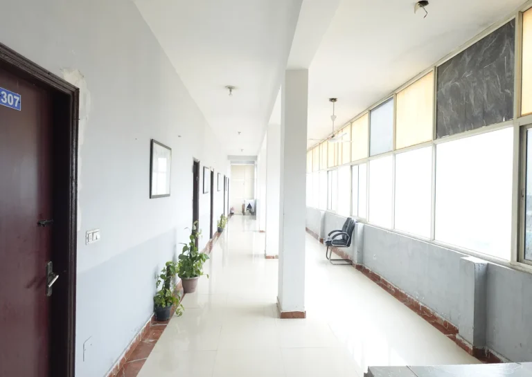 Bright residential hallway with large windows at Saksham by Kriti in Gurgaon