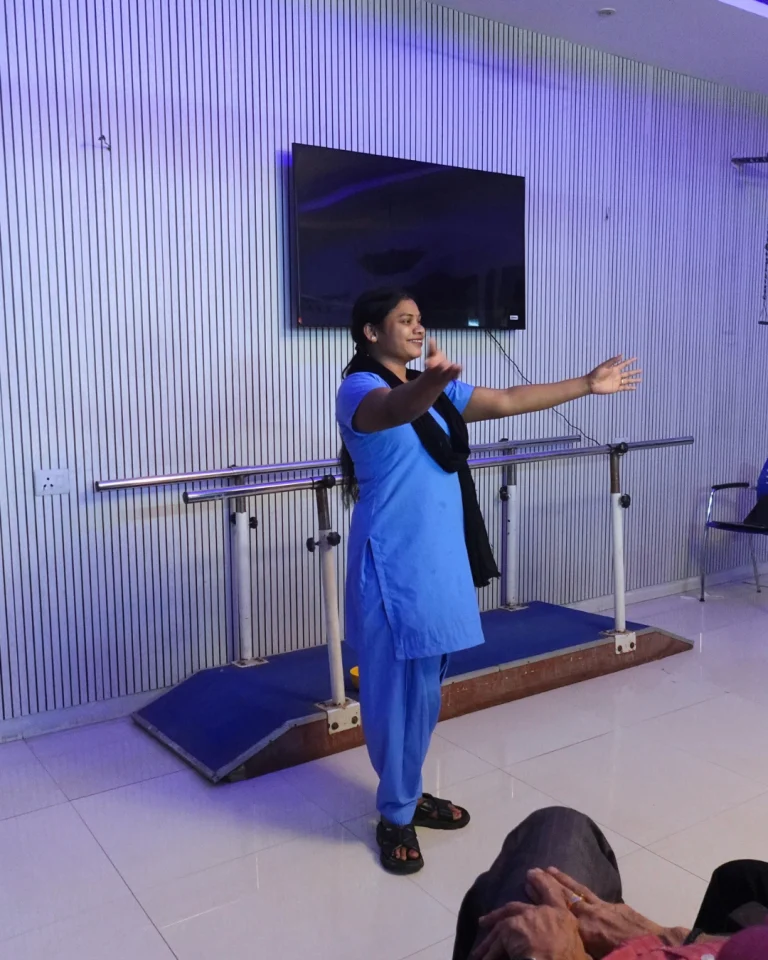 Staff member leading a guided movement activity at Saksham by Kriti