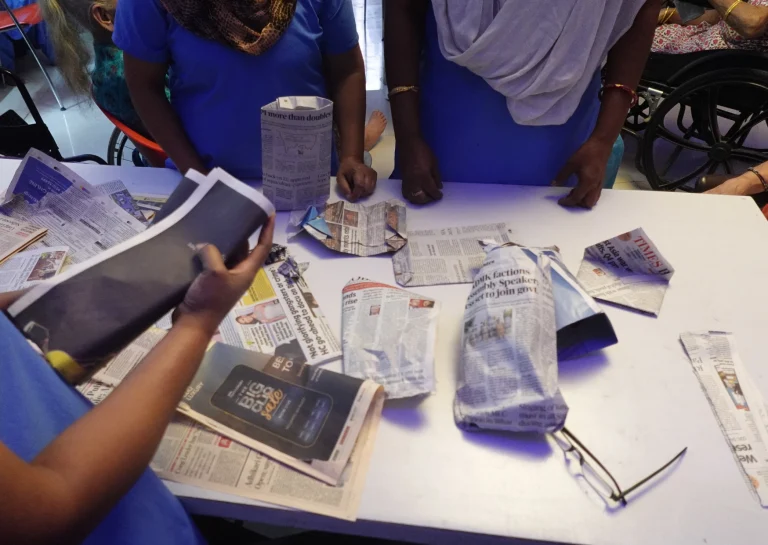 Group activity using newspapers and printed materials at Saksham by Kriti